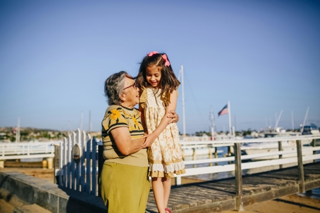 Grandparent hugging grandchild outdoors